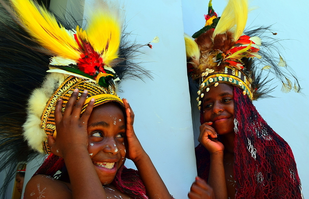 Young Papuan girl  with bird of paradise headdress